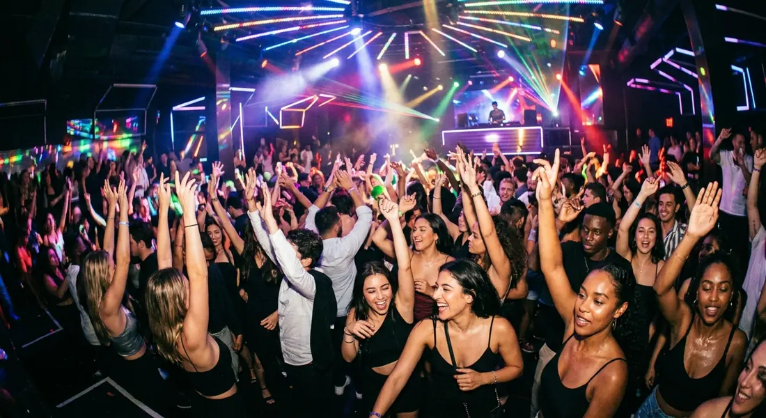 Dansende menigte onder lichtshow in een club