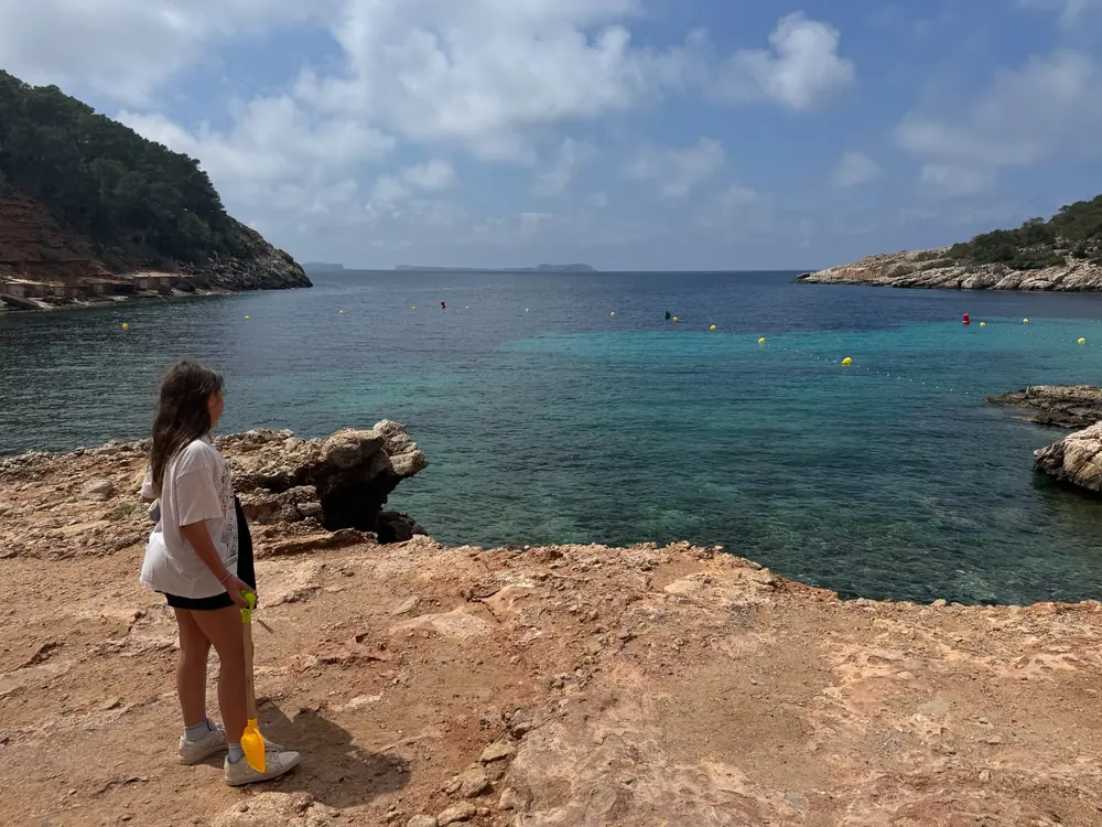 View from the bay of Cala Salada out to the open sea with the two wooded headlands